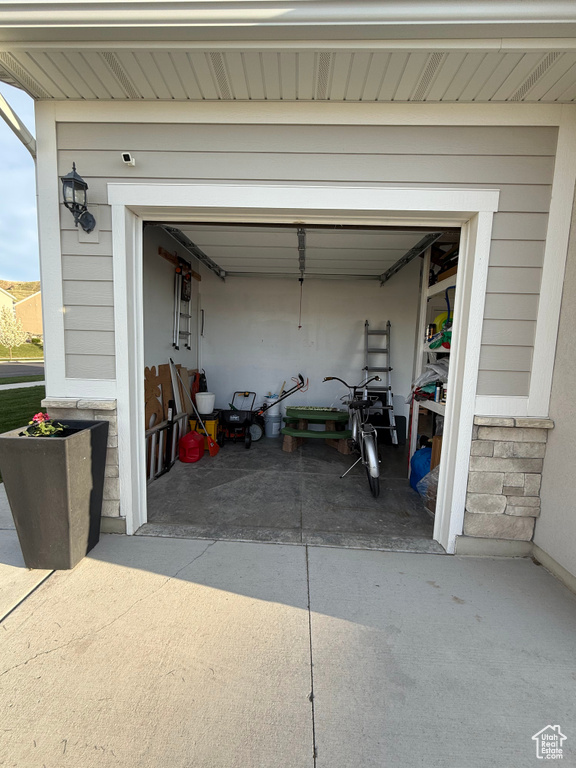 Garage featuring concrete driveway