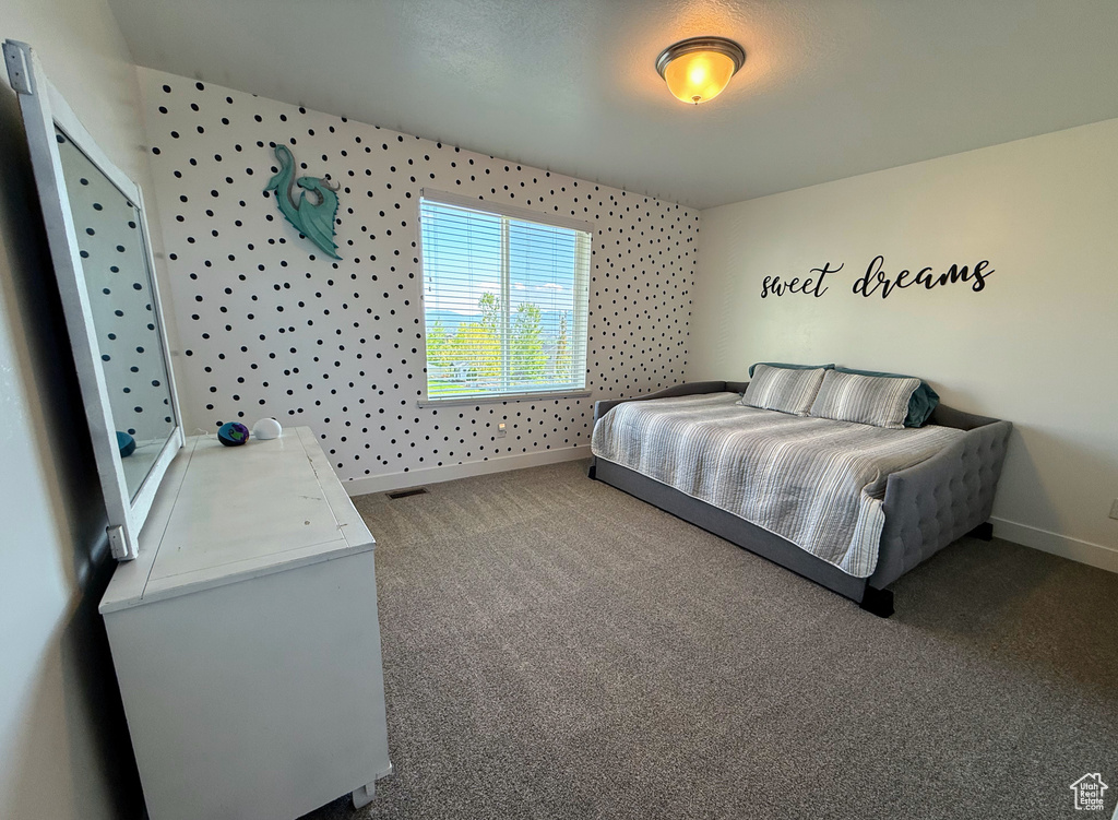 Carpeted bedroom featuring baseboards