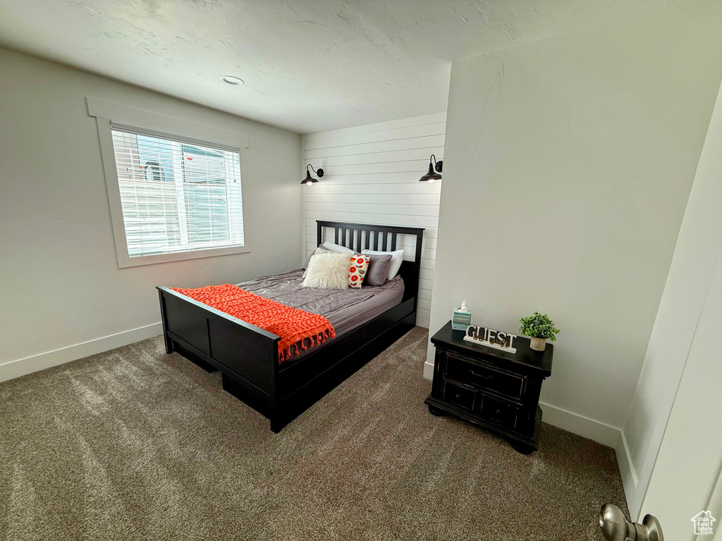 Carpeted bedroom featuring baseboards