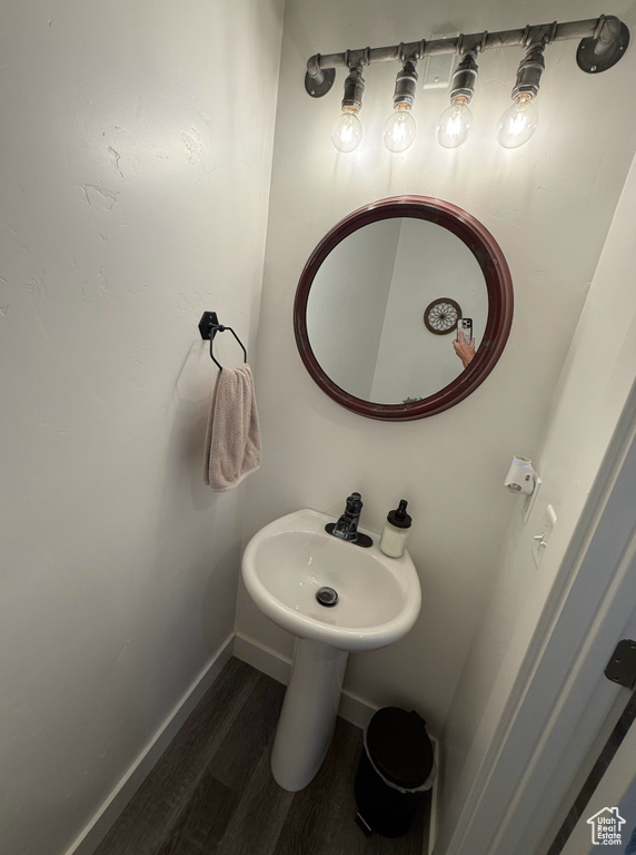 Bathroom with wood finished floors and baseboards