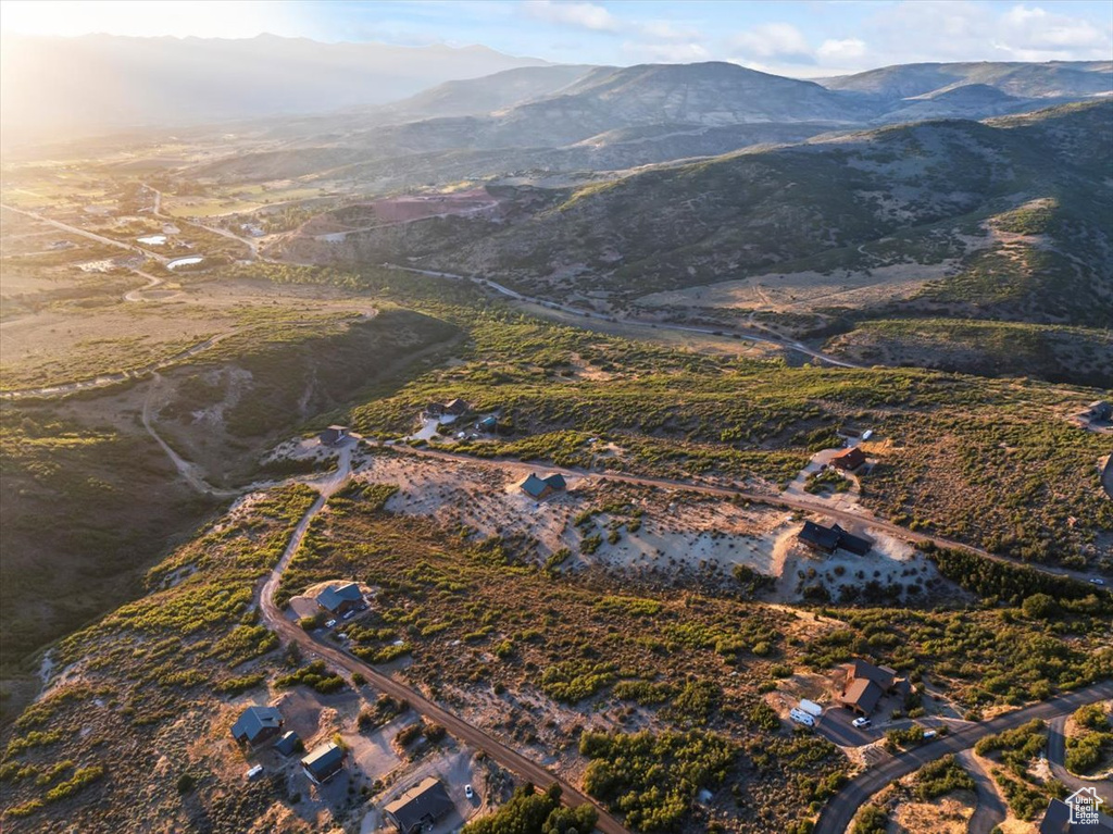 Aerial view of property and surrounding area with a mountainous background