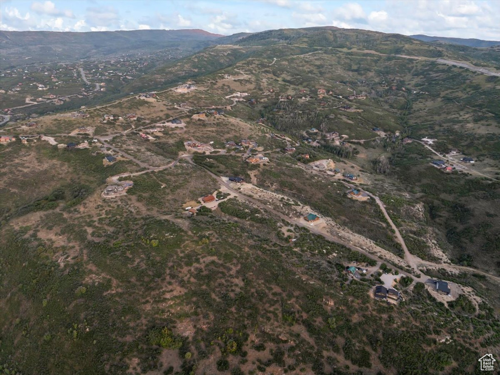 Aerial view of property and surrounding area with a mountain backdrop
