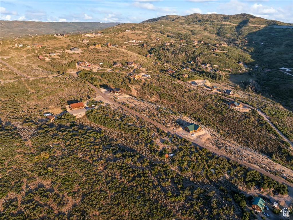 Aerial view of property's location featuring a mountainous background
