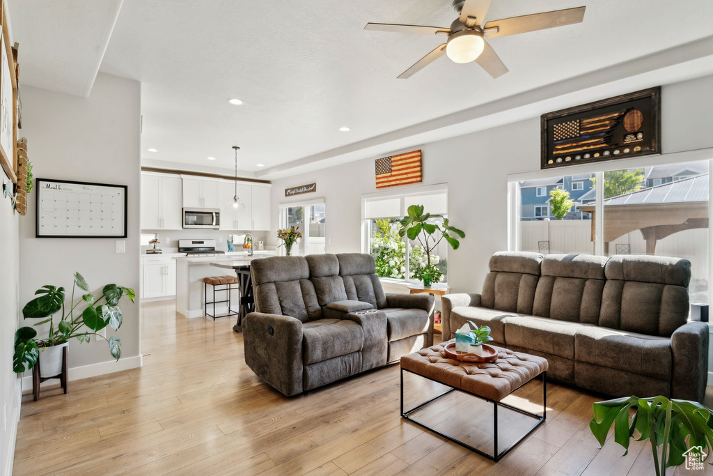 Living room featuring ceiling fan, light wood finished floors, and recessed lighting