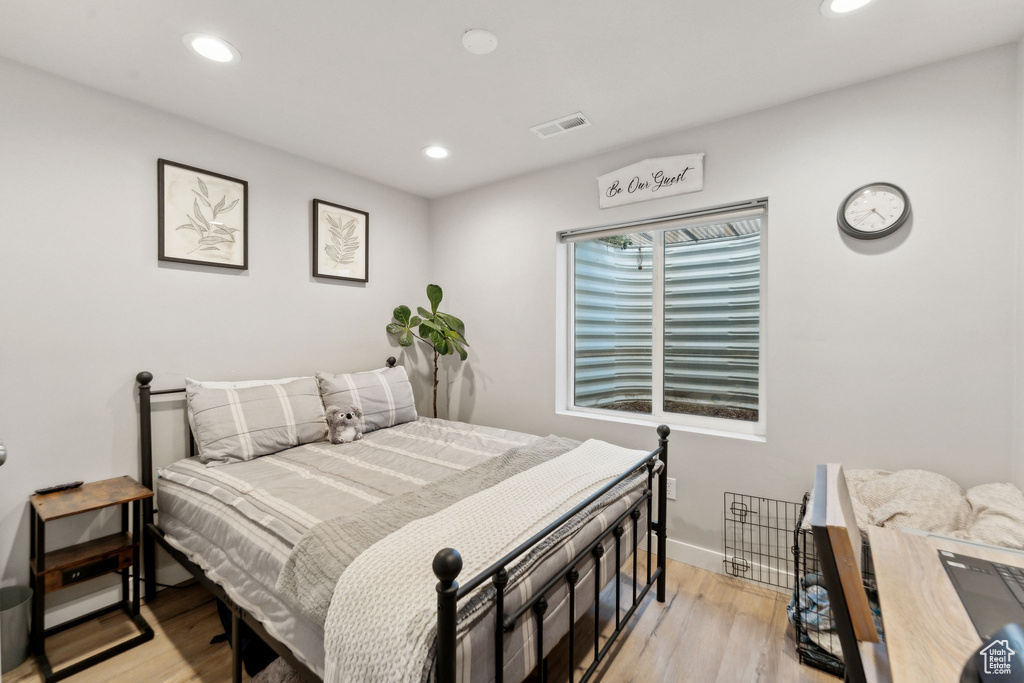 Bedroom featuring light wood-style floors, recessed lighting, and baseboards