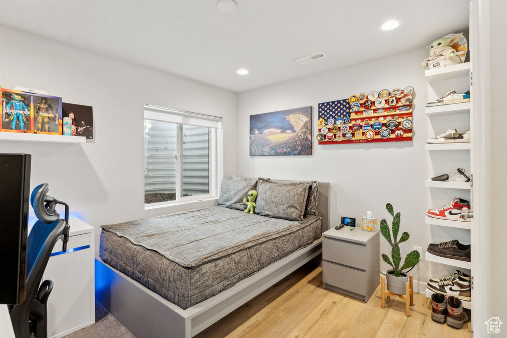 Bedroom with wood finished floors and recessed lighting