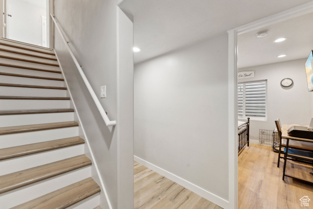 Stairs featuring recessed lighting, wood finished floors, and baseboards