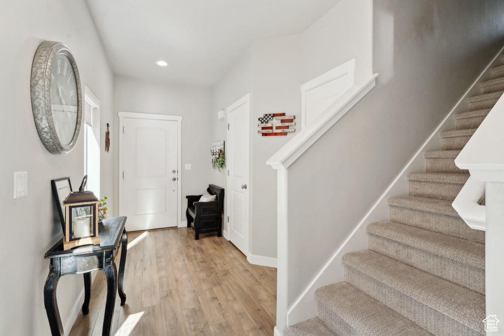 Entryway featuring stairway, light wood-style flooring, recessed lighting, and baseboards