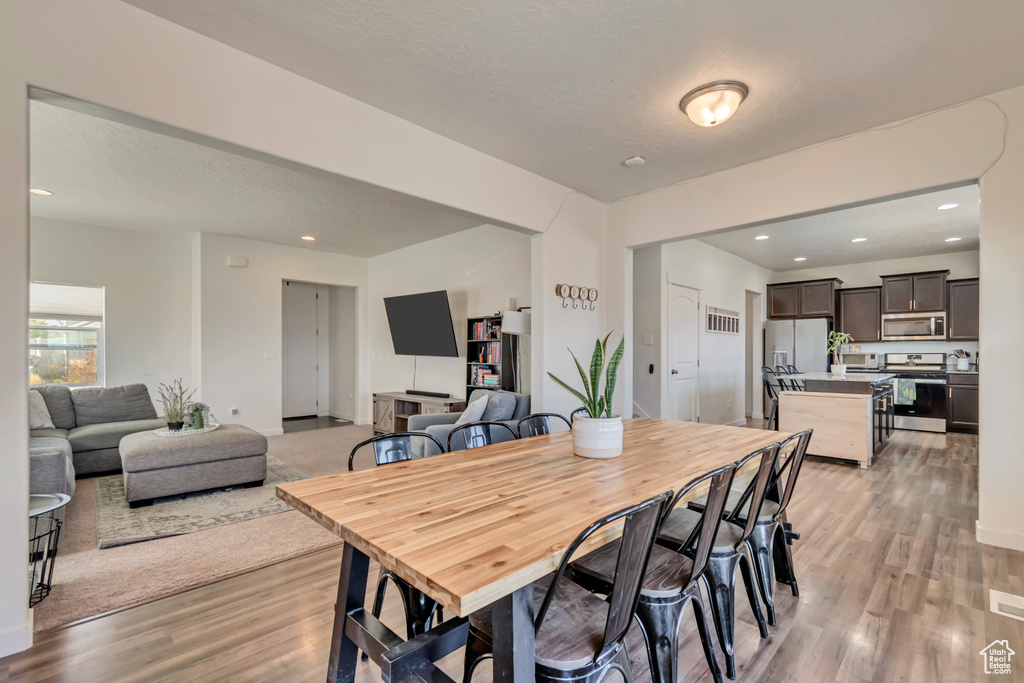 Dining room featuring light wood-type flooring and recessed lighting