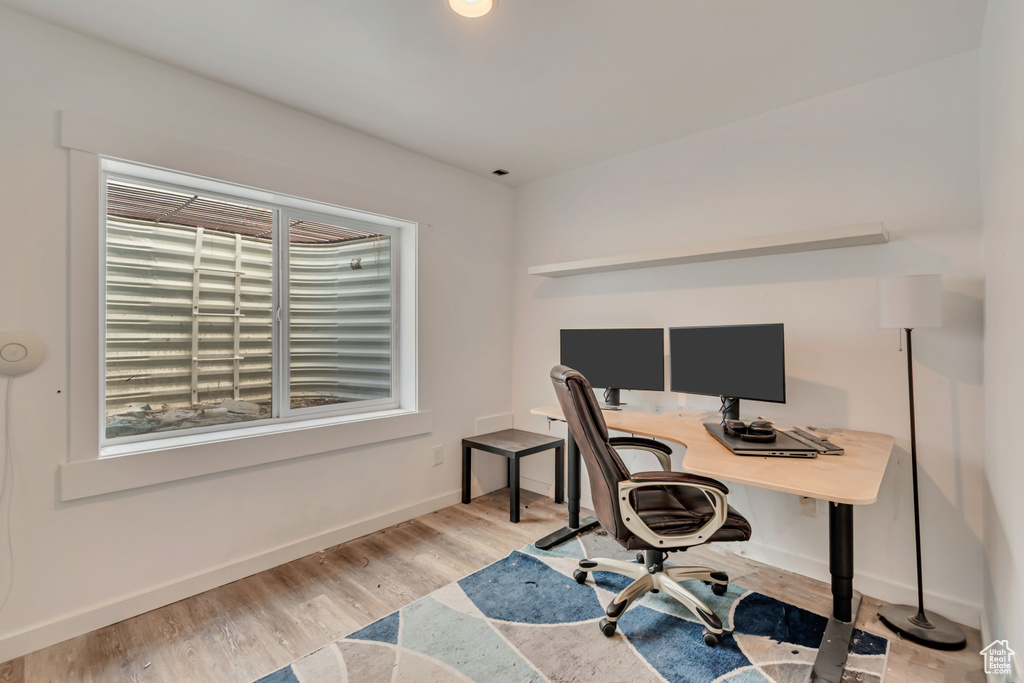 Office with wood finished floors and baseboards