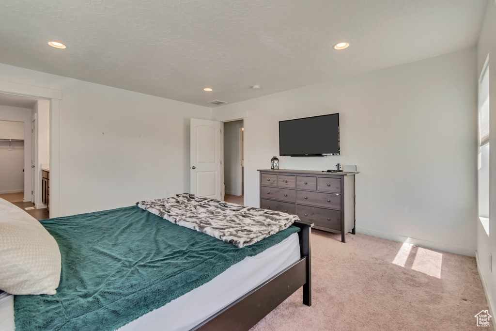 Bedroom featuring recessed lighting, light carpet, and baseboards