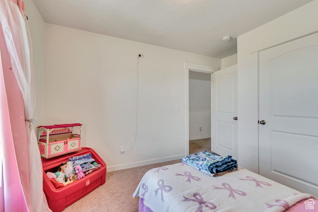 Carpeted bedroom featuring baseboards