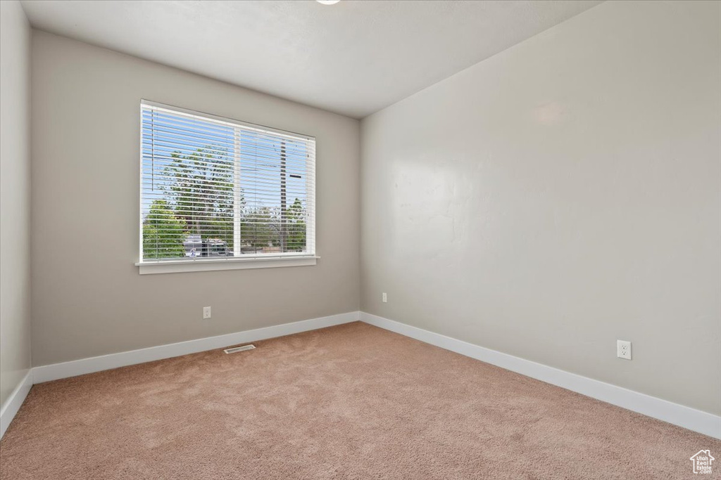 Empty room with carpet floors and baseboards