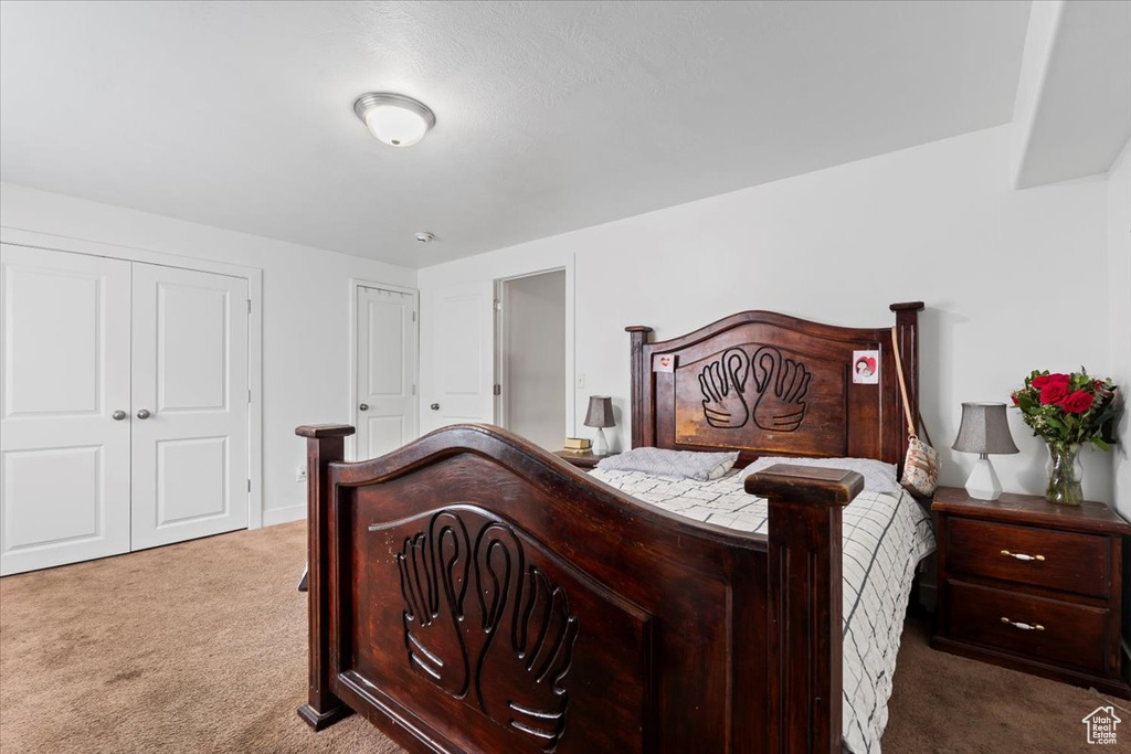 Carpeted bedroom featuring baseboards