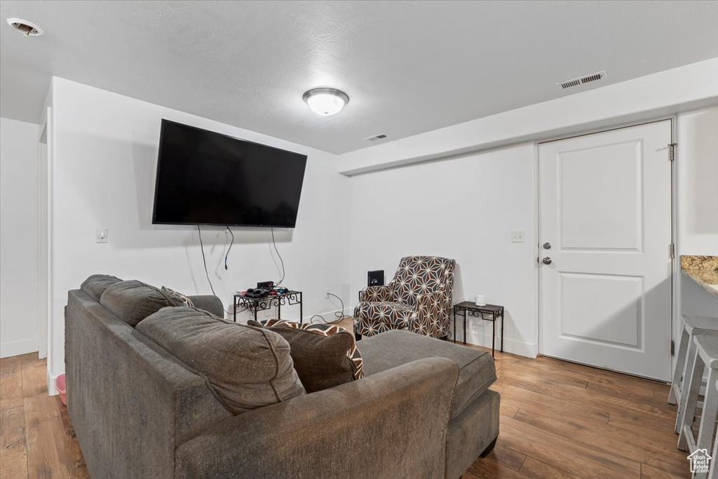 Living room with hardwood / wood-style flooring and baseboards