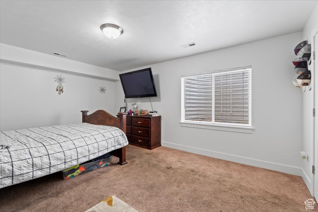 Carpeted bedroom featuring baseboards