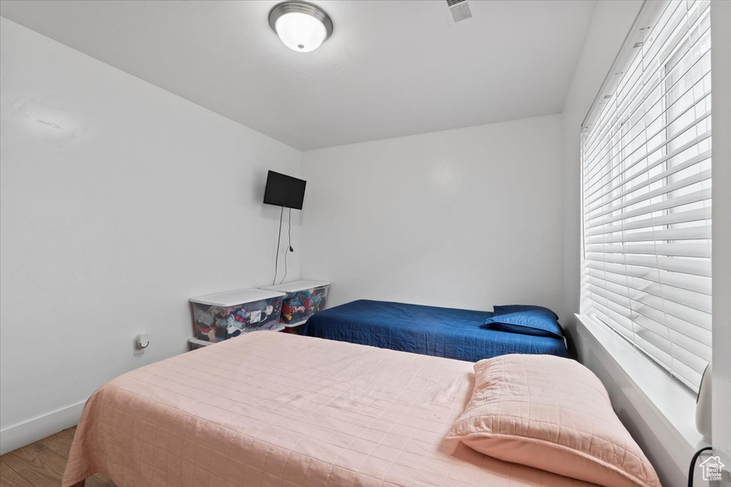 Bedroom featuring wood finished floors and baseboards