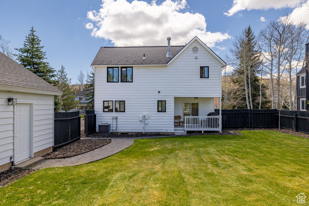 Rear view of house with central AC unit