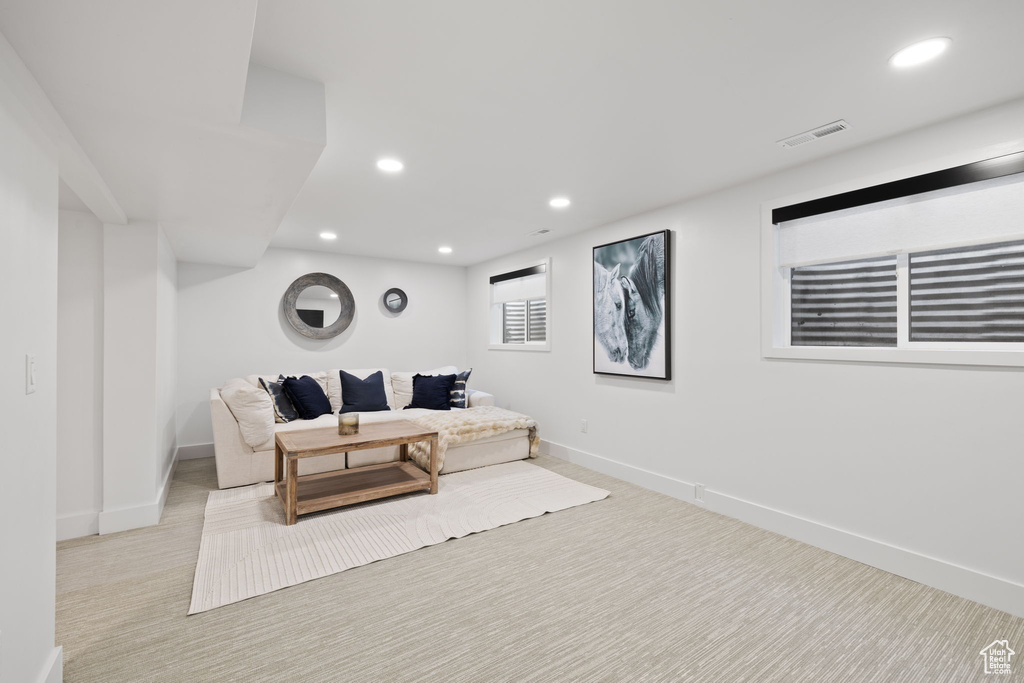 Living area featuring baseboards, carpet flooring, and recessed lighting