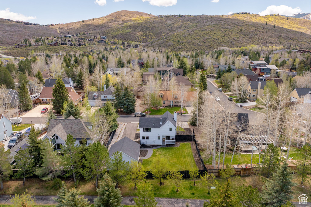 Aerial perspective of suburban area featuring a mountain backdrop