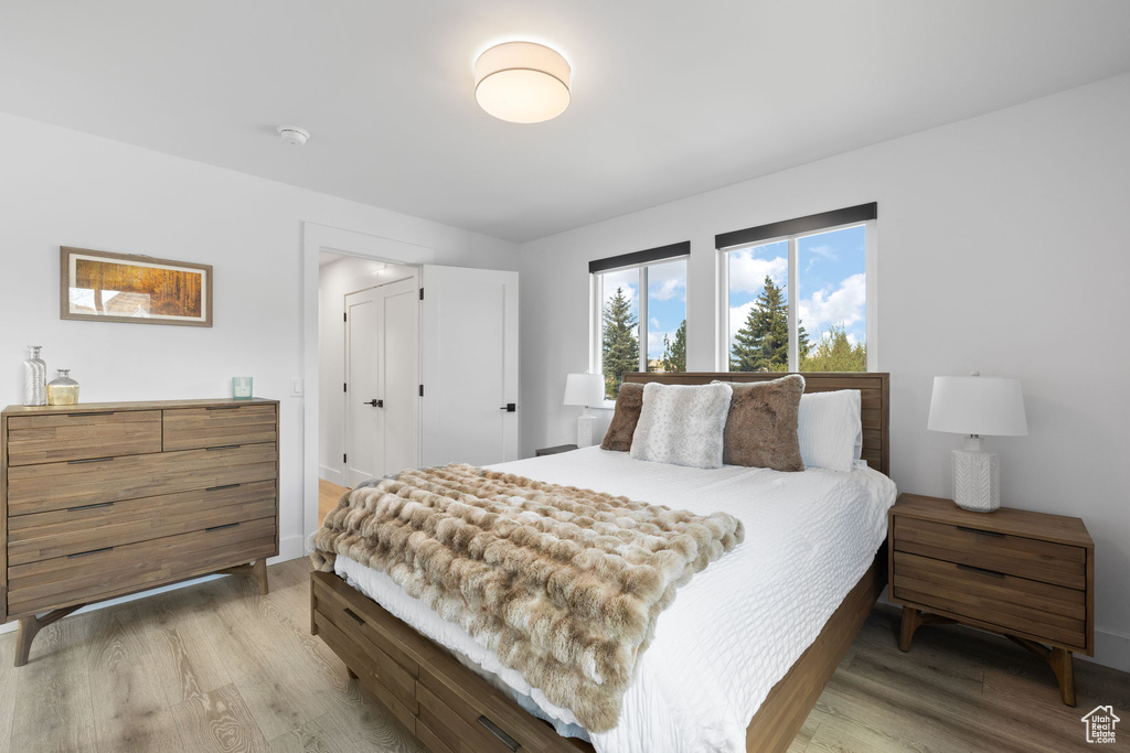 Bedroom featuring light wood-type flooring and baseboards