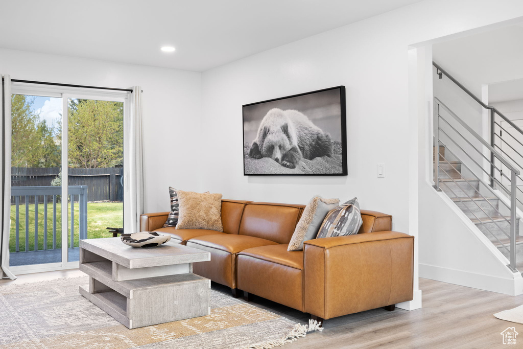 Living area featuring stairs, wood finished floors, recessed lighting, and baseboards