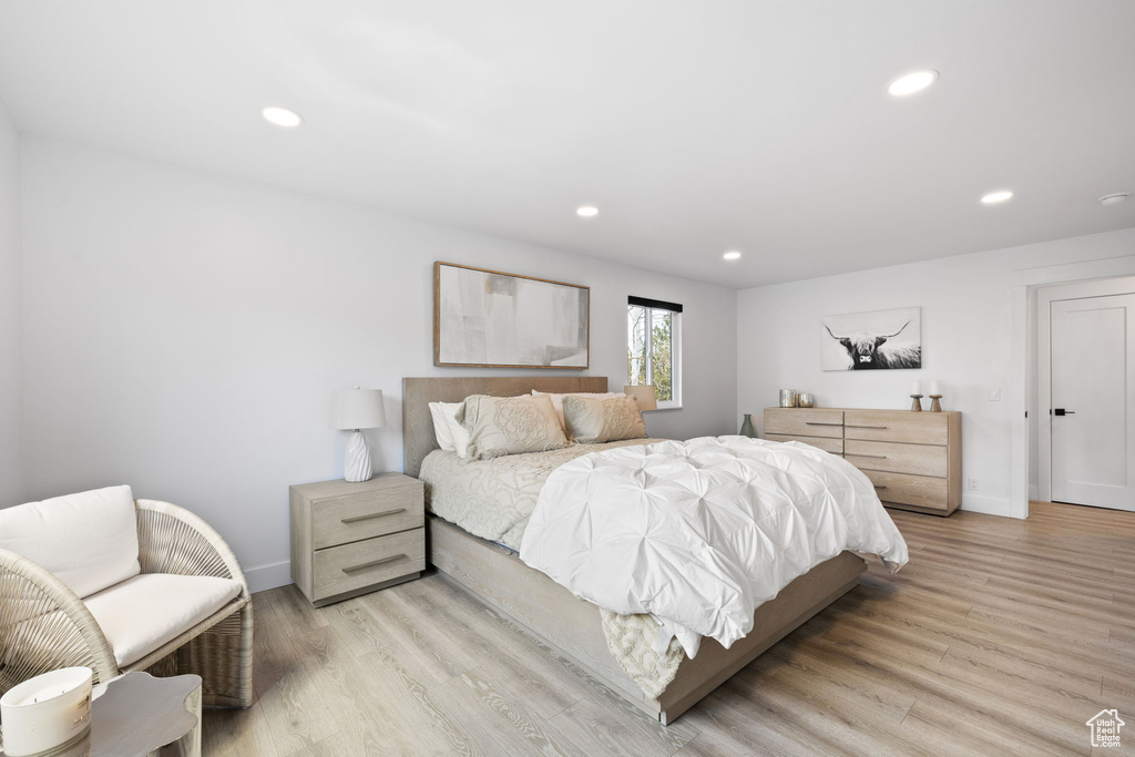 Bedroom with recessed lighting, light wood-style floors, and baseboards