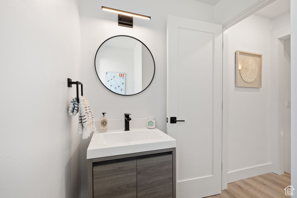 Bathroom featuring vanity and wood finished floors