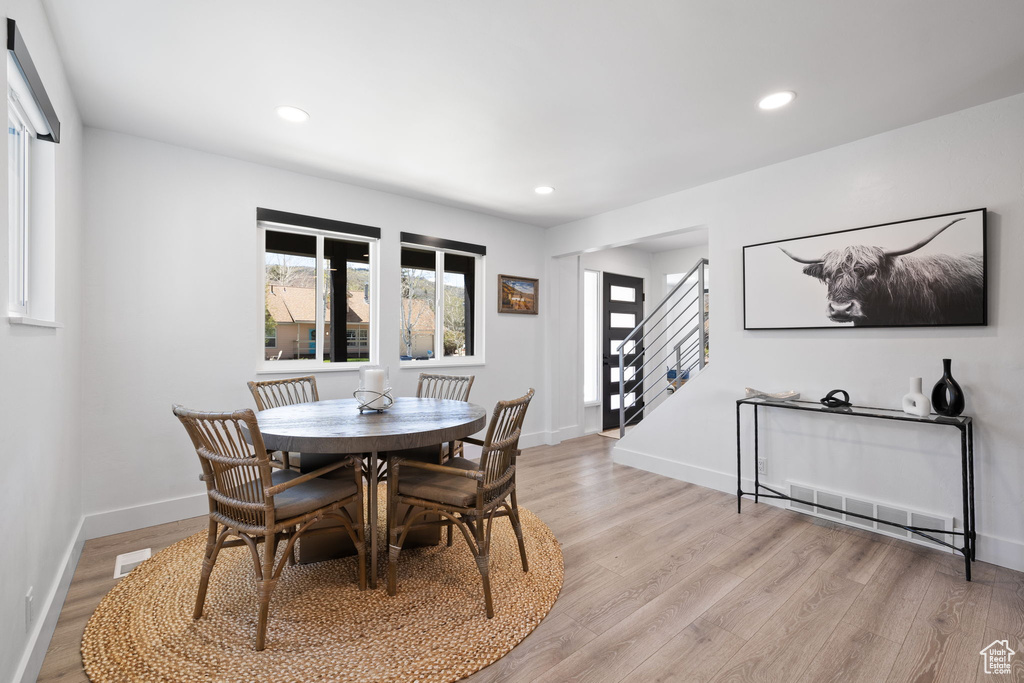 Dining area with stairs, light wood-type flooring, recessed lighting, and baseboards