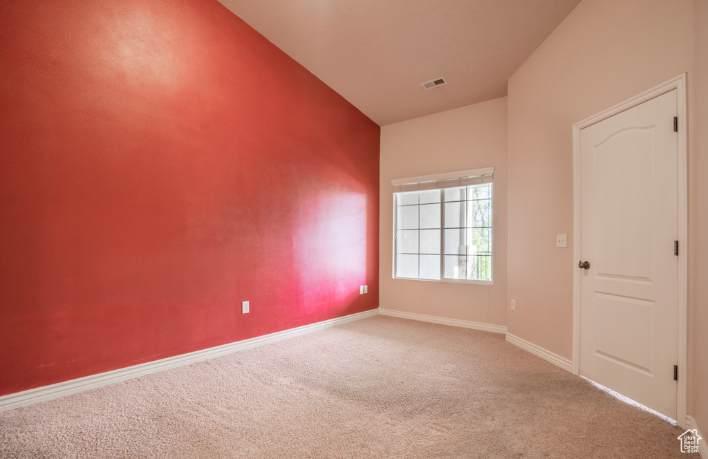 Carpeted empty room with baseboards