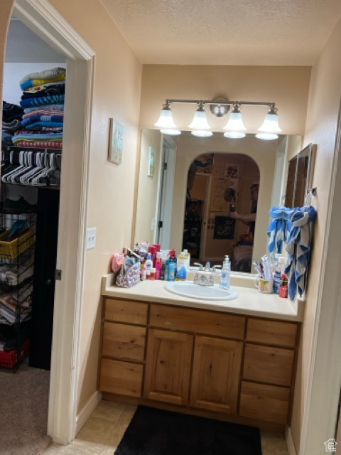 Bathroom with vanity and a textured ceiling