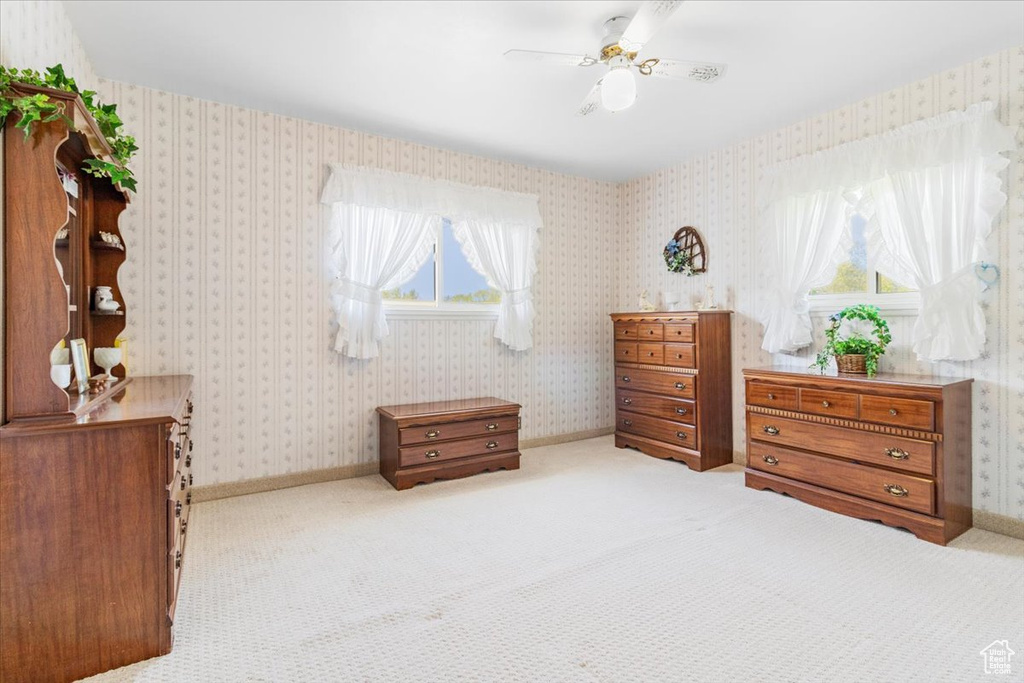 Carpeted bedroom with ceiling fan