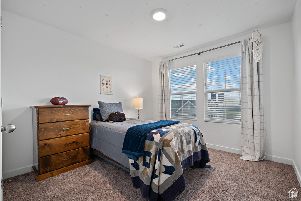 Bedroom with carpet floors and baseboards