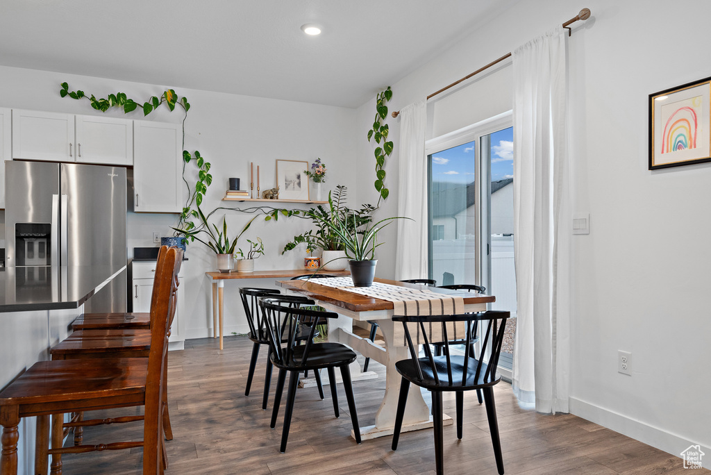 Dining space featuring wood finished floors, recessed lighting, and baseboards