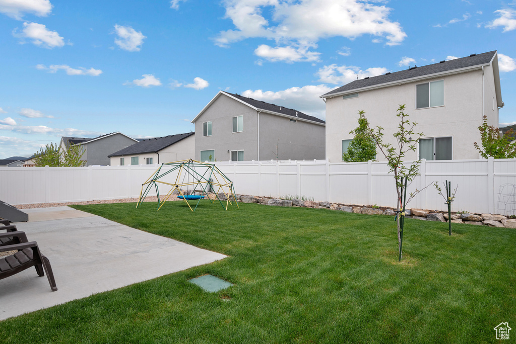 View of yard featuring a playground and a patio