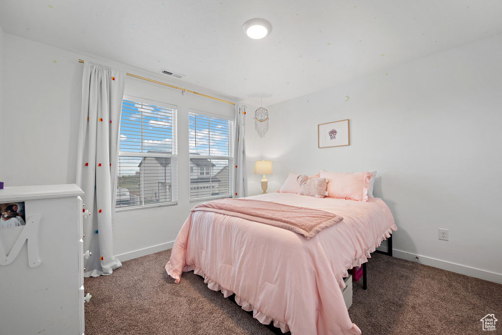 Carpeted bedroom featuring baseboards
