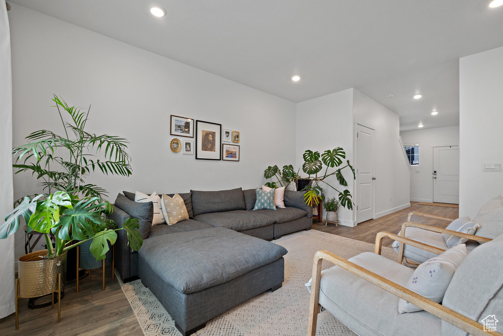 Living room featuring wood finished floors, recessed lighting, and baseboards