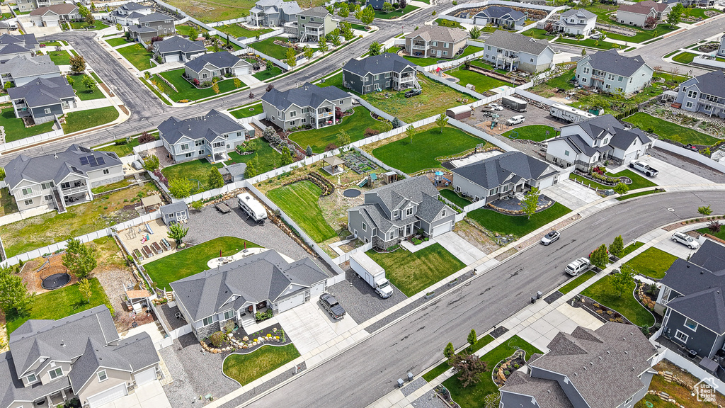 Aerial view of property and surrounding area with nearby suburban area