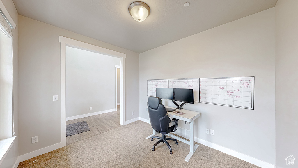 Home office featuring carpet flooring and baseboards