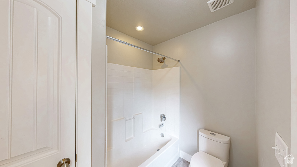 Full bathroom with toilet, shower / bath combination, and recessed lighting