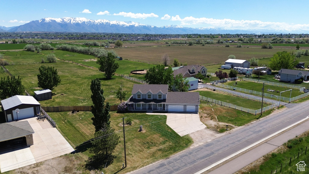 Overview of rural landscape featuring a mountain backdrop and agricultural land