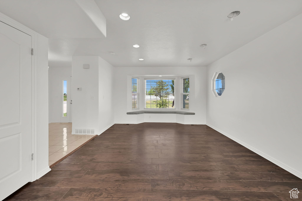 Empty room with recessed lighting, wood finished floors, and baseboards