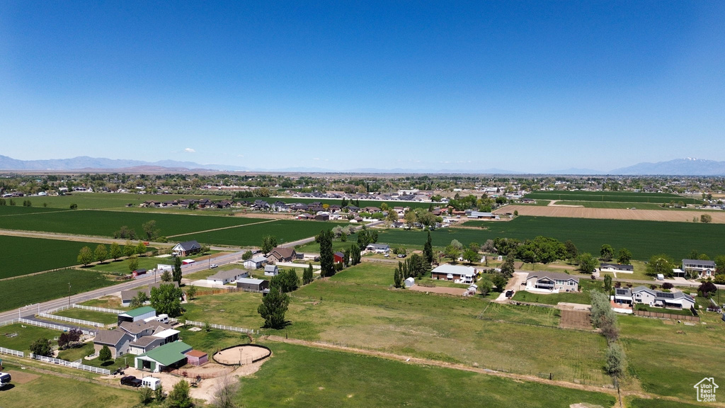 Aerial view of property\'s location featuring rural landscape and a mountainous background