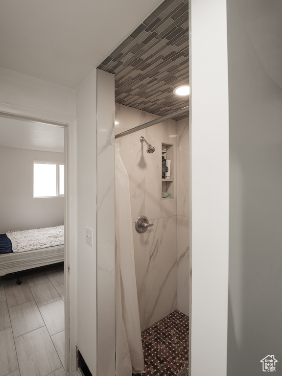 Bathroom with a marble finish shower