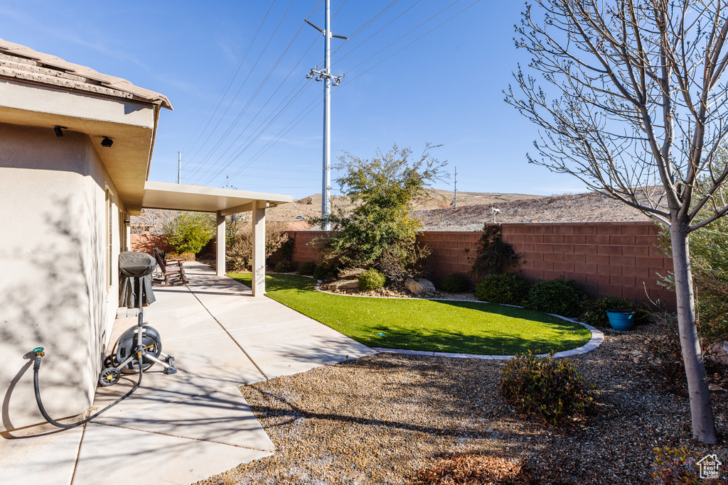 View of yard featuring a fenced backyard and a patio area
