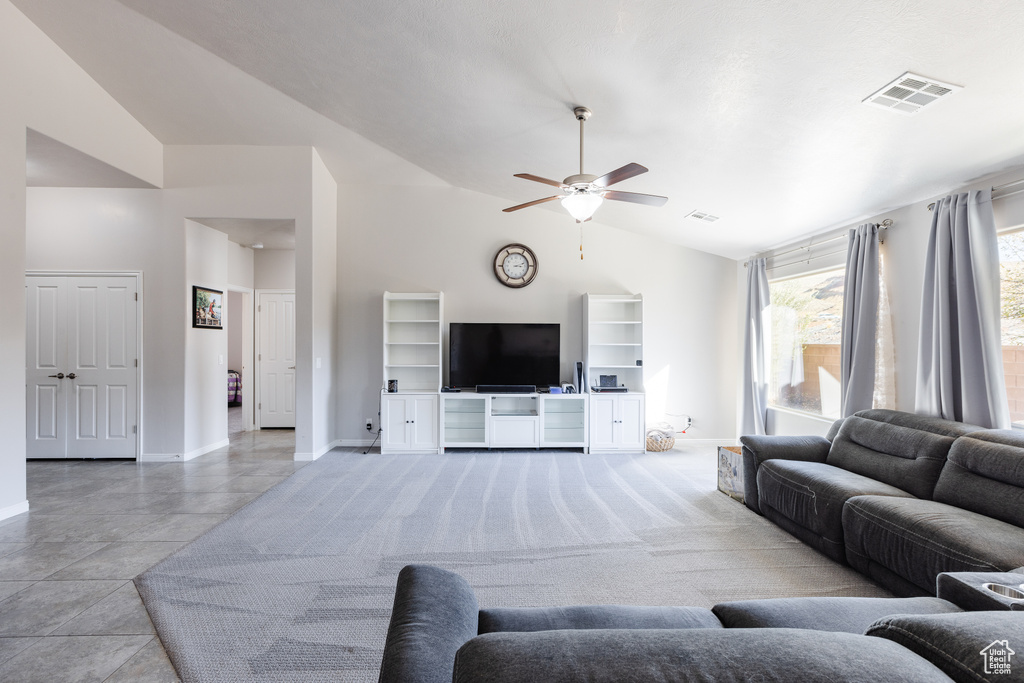 Living room featuring visible vents, ceiling fan, high vaulted ceiling, and baseboards