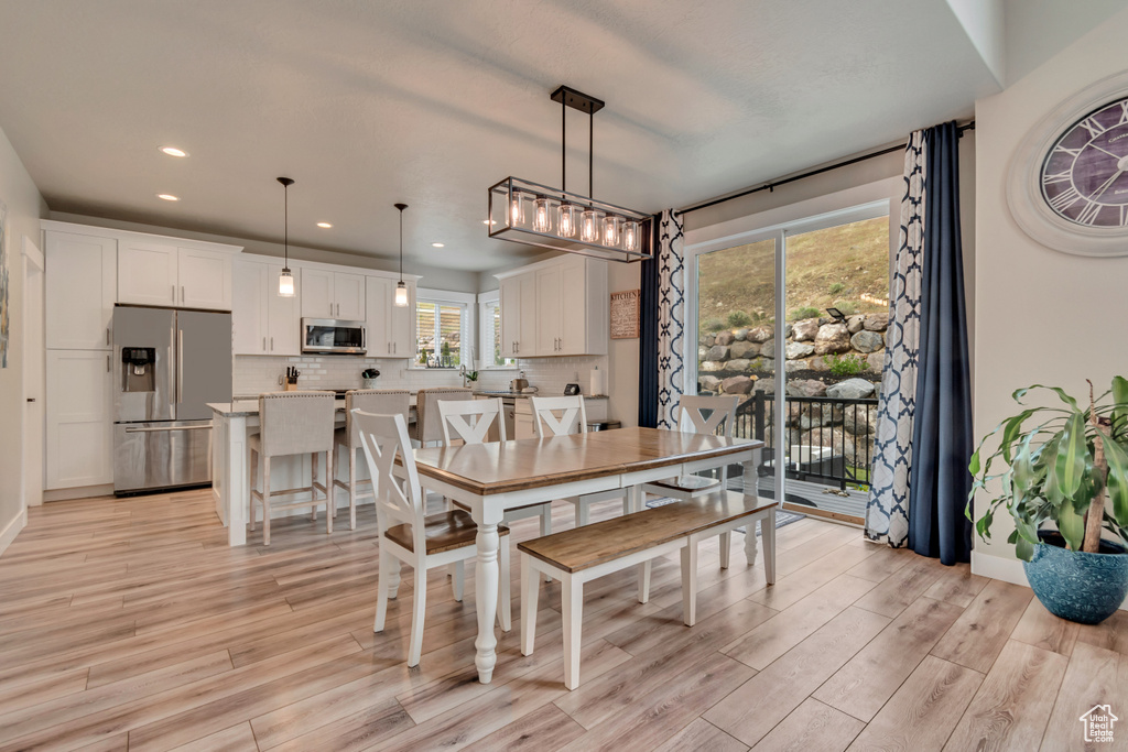 Dining area featuring light wood-style flooring, recessed lighting, and baseboards