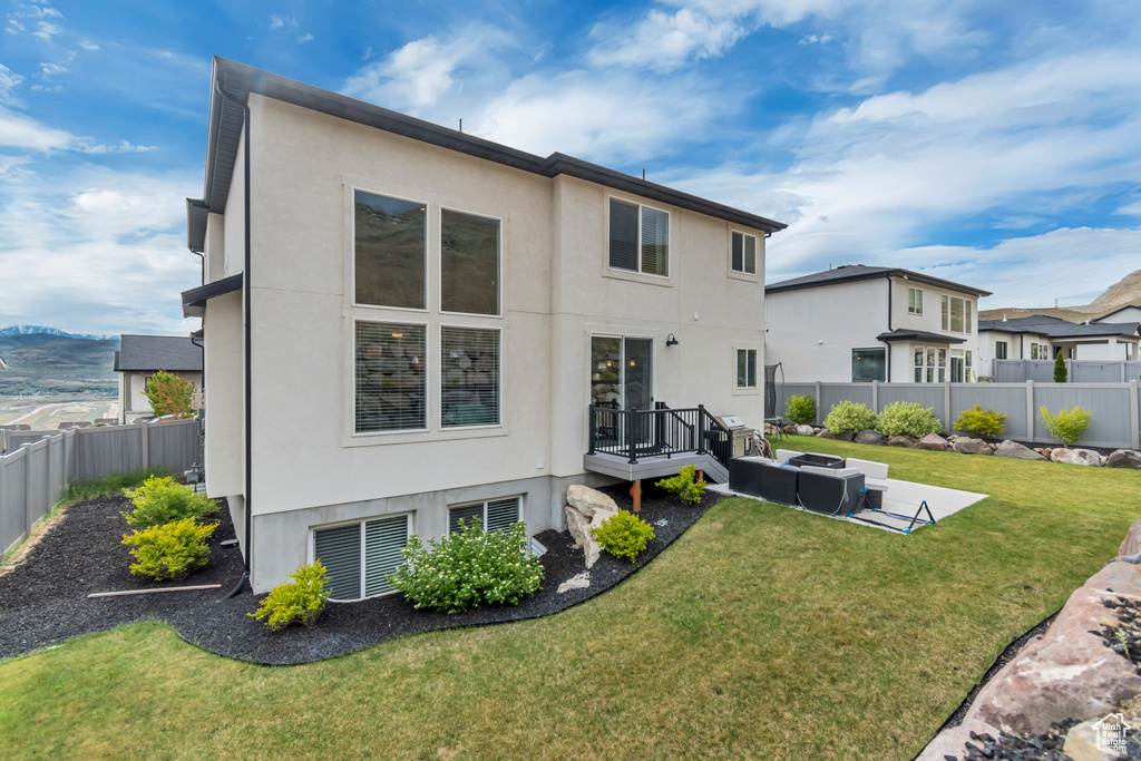 Back of property featuring stucco siding and an outdoor hangout area