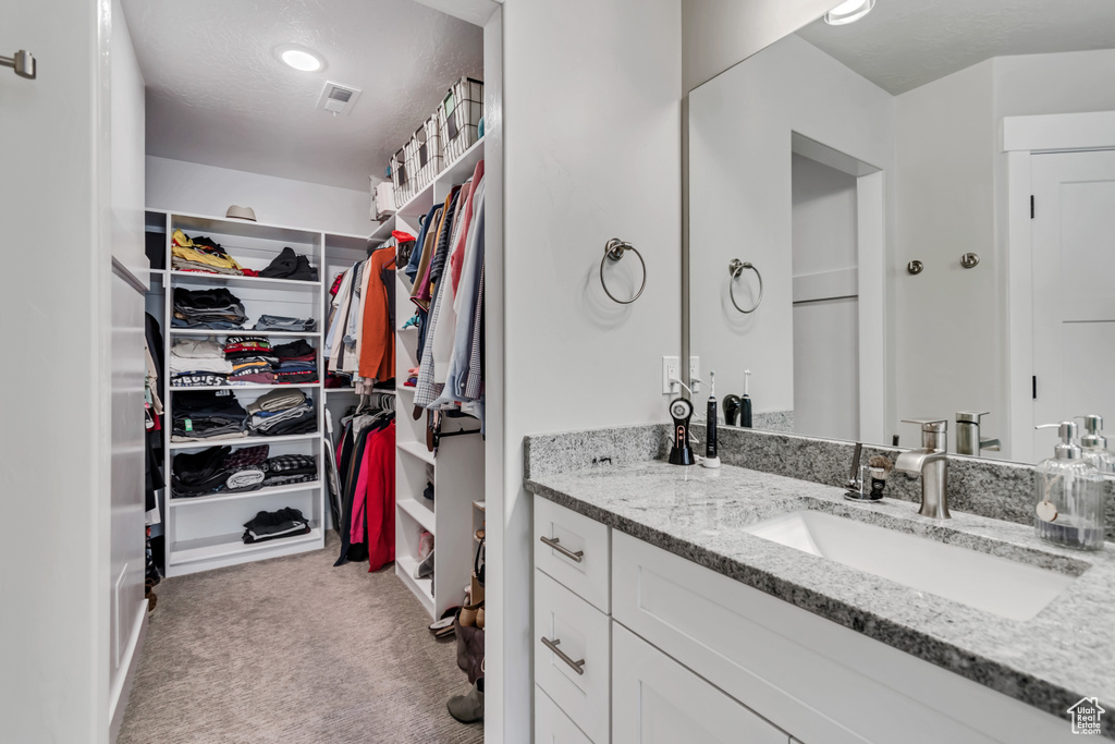 Bathroom with a spacious closet and vanity