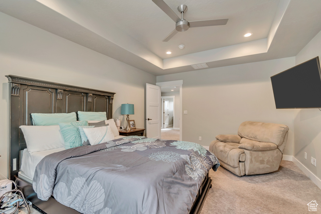 Bedroom with recessed lighting, a tray ceiling, ceiling fan, light colored carpet, and baseboards
